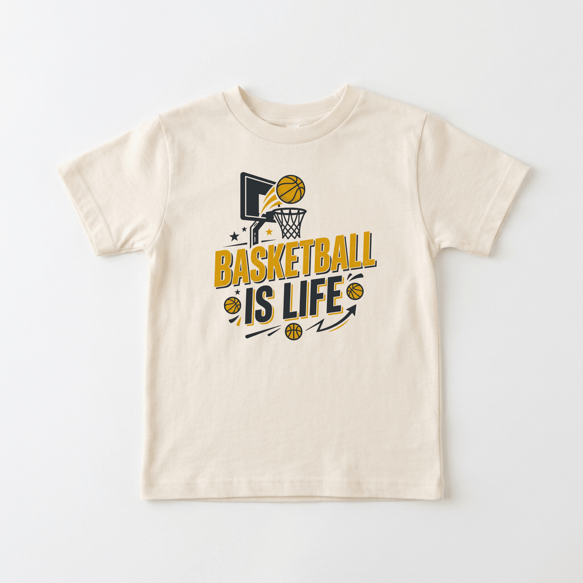 The Toodleroos Basketball Is Life Youth Shirt is a beige kids tee featuring a basketball hoop graphic, two basketballs, stars, and bold yellow and black lettering that reads “BASKETBALL IS LIFE.” Perfect for young sports fans, this sports-themed t-shirt makes a great choice for any basketball-loving kid.