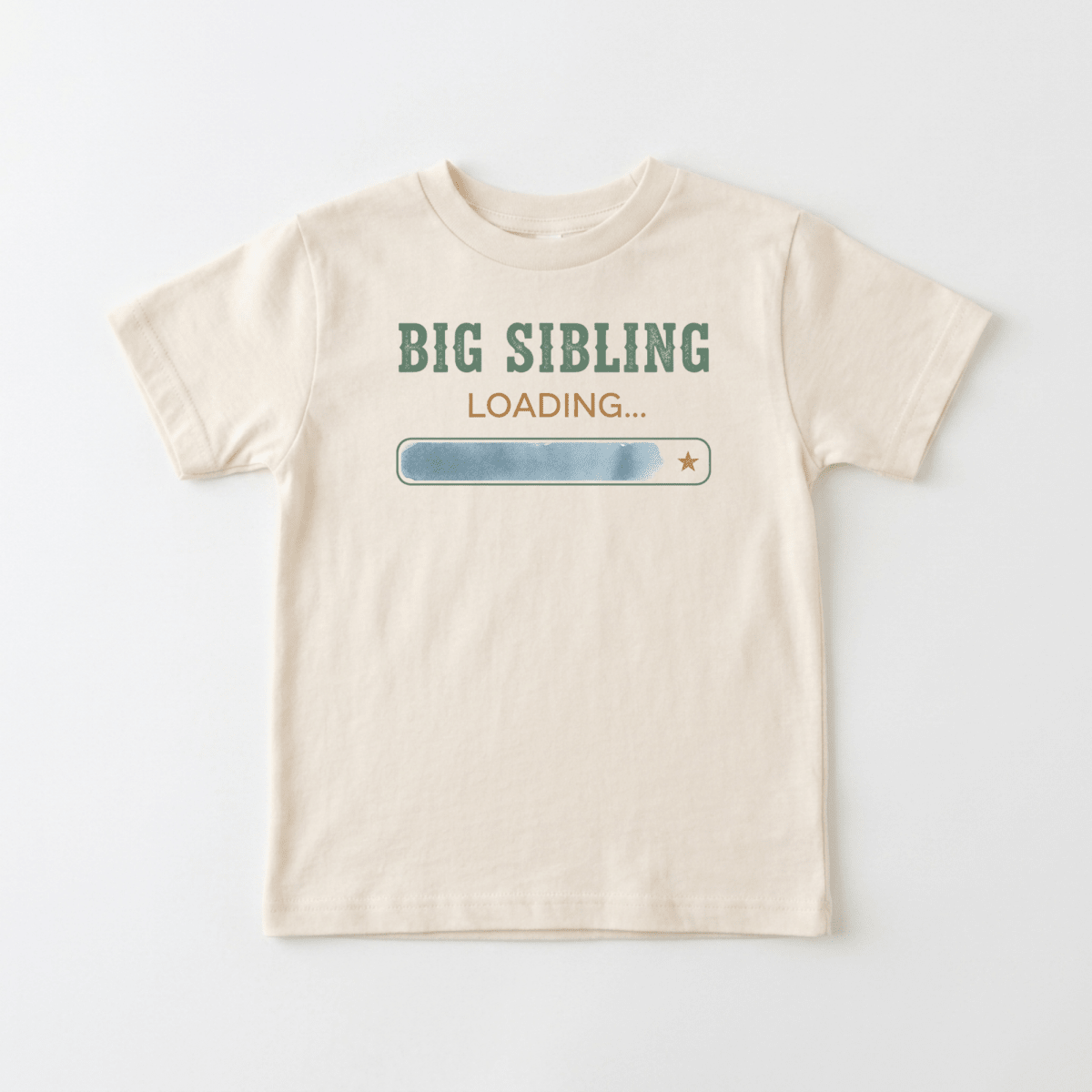 Dress your little one in the Toodleroos Big Sibling Loading Toddler Shirt – Pregnancy Announcement! This cute beige tee features green “BIG SIBLING” text above a blue loading bar graphic with a small star on the right, and “LOADING...” written underneath. Perfect for announcing a pregnancy or as a sweet toddler shirt to celebrate a new family member on the way.