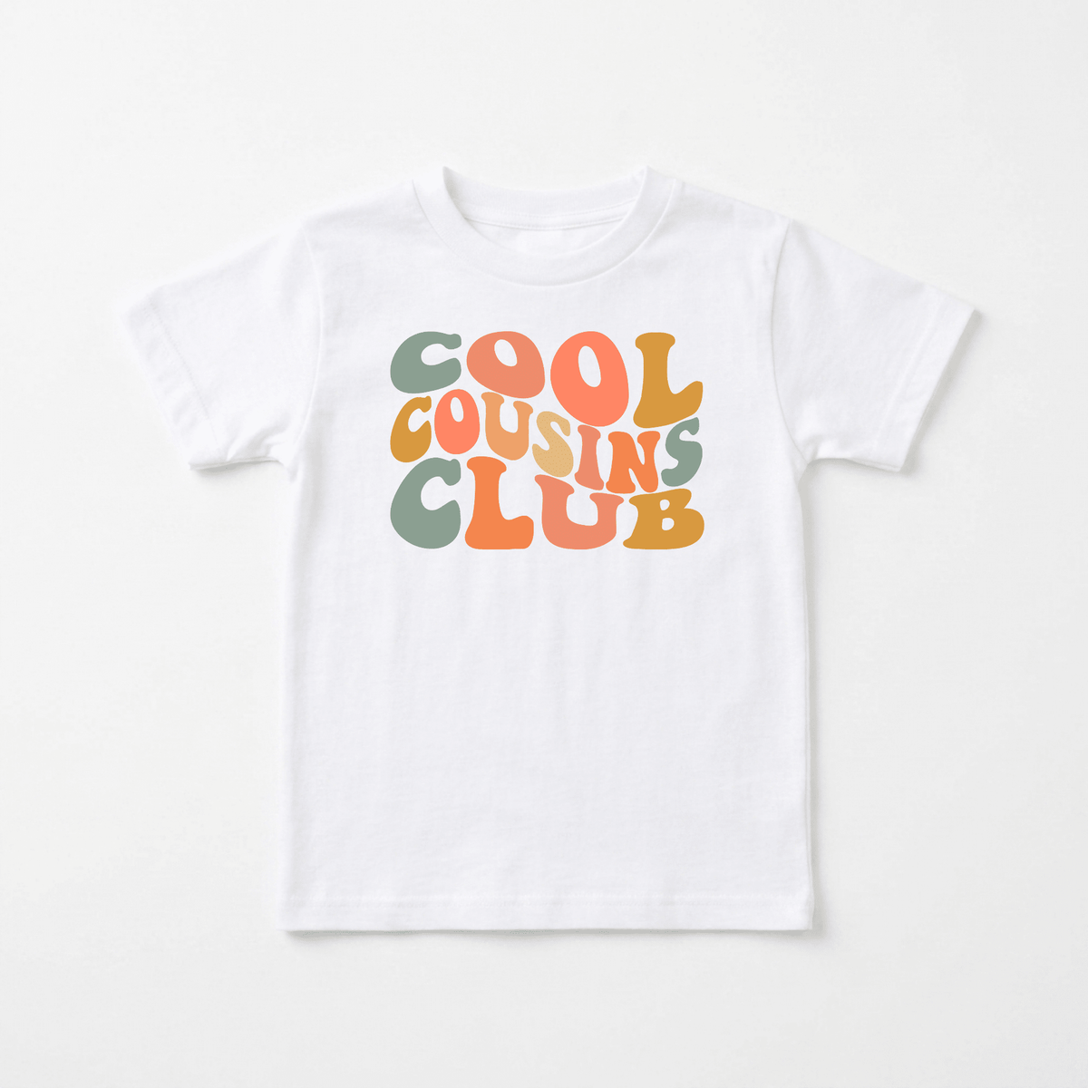 The Toodleroos Cool Cousins Club Toddler Shirt – Retro Family Tee features “COOL COUSINS CLUB” in bold, playful retro-style lettering across the front in green, orange, and yellow. Perfect for matching cousin outfits or as a fun family reunion toddler shirt, this tee adds extra charm to every gathering.