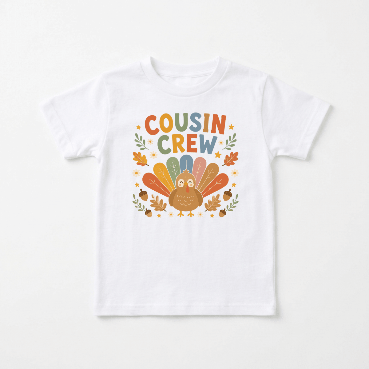 Introducing the Toodleroos Thanksgiving Cousin Shirt – Cousin Crew Turkey Toddler Tee: a white T-shirt featuring a vibrant cartoon turkey, autumn leaves, and bold “Cousin Crew” lettering above the turkey. This adorable tee is perfect for family gatherings and makes an ideal toddler Thanksgiving shirt with its festive autumn and Thanksgiving-themed design.