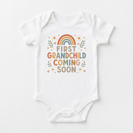 Introducing the Toodleroos First Grandchild Pregnancy Announcement Onesie – Coming Soon Short-Sleeve Bodysuit! This charming white baby bodysuit features a vibrant rainbow, cheerful flowers, and playful “First Grandchild Coming Soon” text—making it the perfect choice for a grandparent reveal or a memorable pregnancy announcement. Share your special news with this adorable onesie and delight family and friends!.