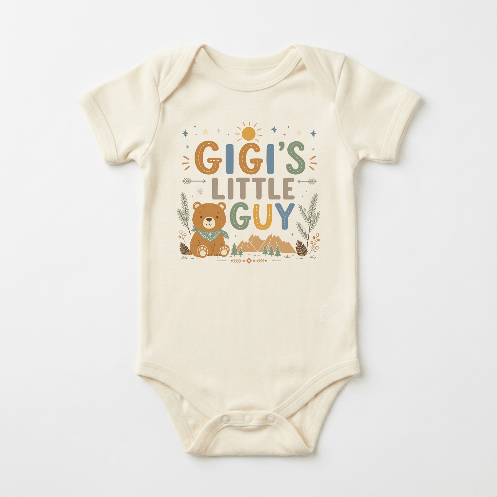 The Toodleroos Gigi’s Little Guy Baby Onesie – Woodland Bear Design features a playful, nature-inspired print with a cute bear, leafy plants, trees, and tiny stars in earthy tones on the front. With “Gigi’s Little Guy” text in soft cream fabric, this charming bodysuit makes a wonderful baby shower gift or a sweet outfit for your grandson.
