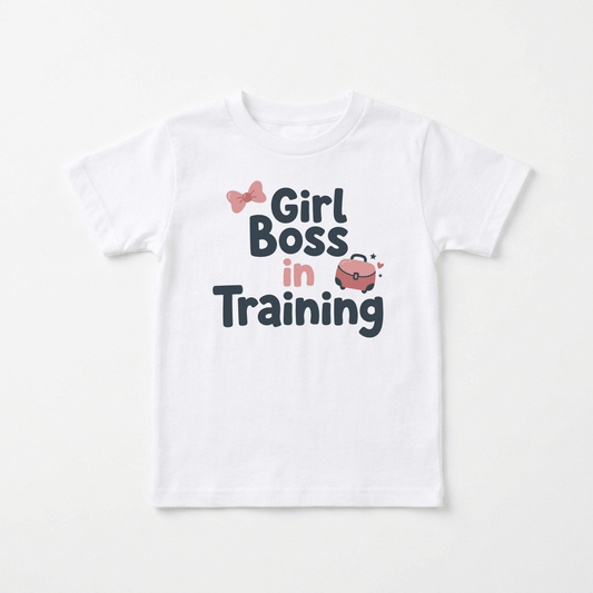 Dress your little leader in style with the Toodleroos “Girl Boss in Training Toddler Girls Shirt – Confident Bow Tee.” This adorable white toddler tee features playful pink and black text reading “Girl Boss in Training,” a cute pink bow above “Girl,” and a sparkling pink purse graphic nearby. Perfect for future bosses, this must-have toddler graphic shirt combines fun design with empowering flair—an ideal choice for confident girls who love stylish tees!.