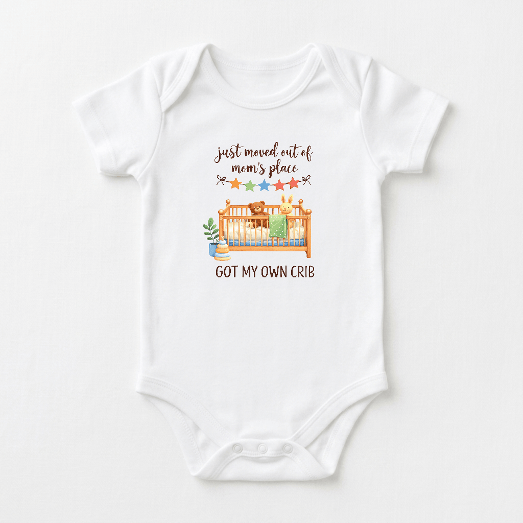 Introducing the Toodleroos Funny Baby Onesie – Got My Own Crib Short-Sleeve Infant Bodysuit. This white infant bodysuit features a delightful illustration of a crib surrounded by stars and plants, with the playful text “just moved out of moms place” above and “GOT MY OWN CRIB.” below. Perfect as a baby shower gift for new parents, this adorable onesie combines comfort and humor for your little one!.