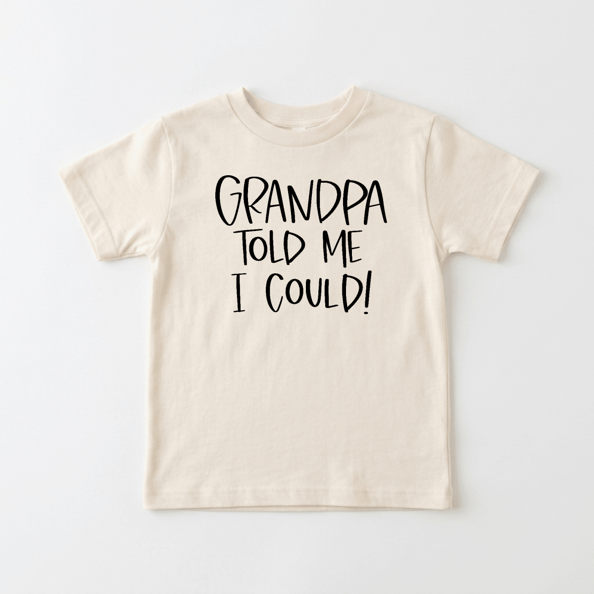 Toodleroos Grandpa Told Me I Could Toddler Shirt – a beige children’s tee featuring the bold, playful phrase “GRANDPA TOLD ME I COULD!” in black on the front—ideal as a funny grandpa gift or special family reunion shirt for toddlers.