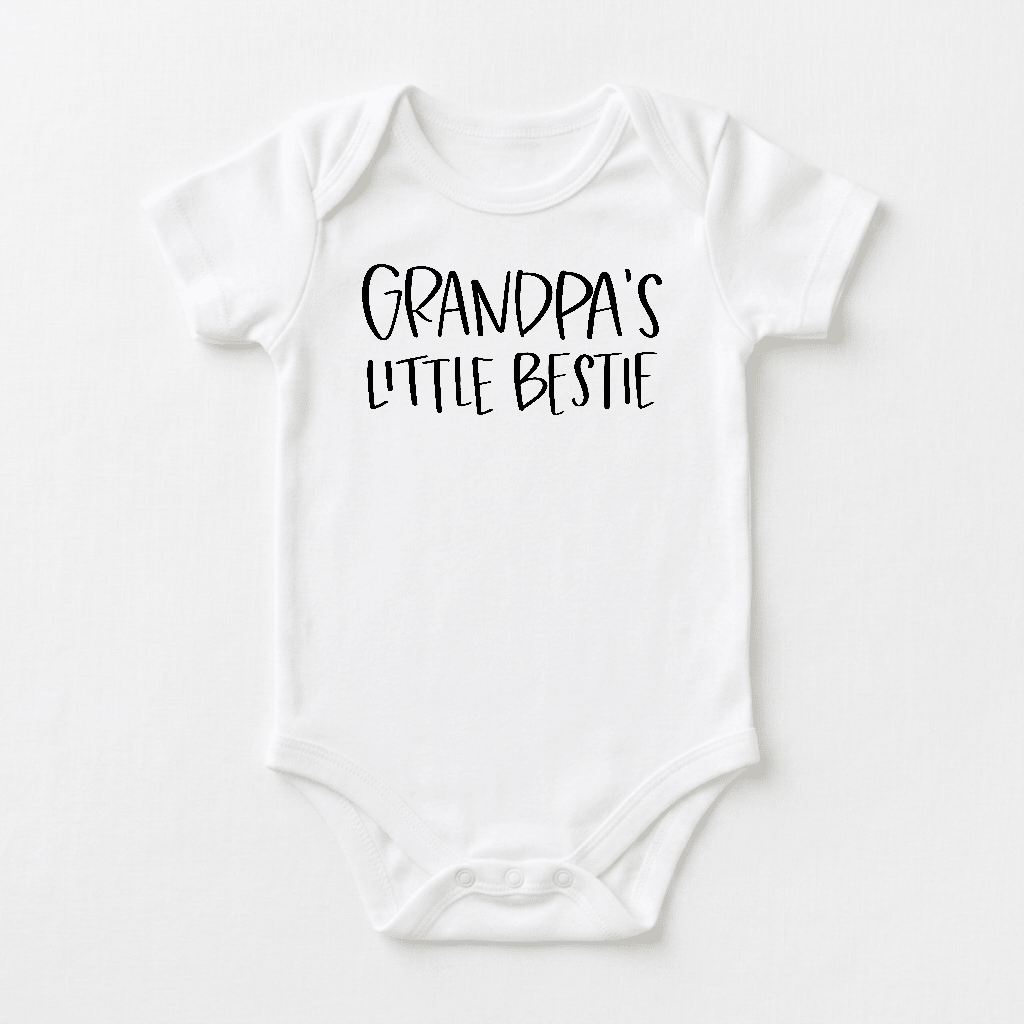 Dress your little one in the Toodleroos Grandpa’s Little Bestie Baby Onesie – a charming white bodysuit featuring “Grandpa’s Little Bestie” in bold, playful black lettering across the chest. This handwritten-style grandpa bodysuit is a delightful and heartwarming baby shower gift from Grandpa.