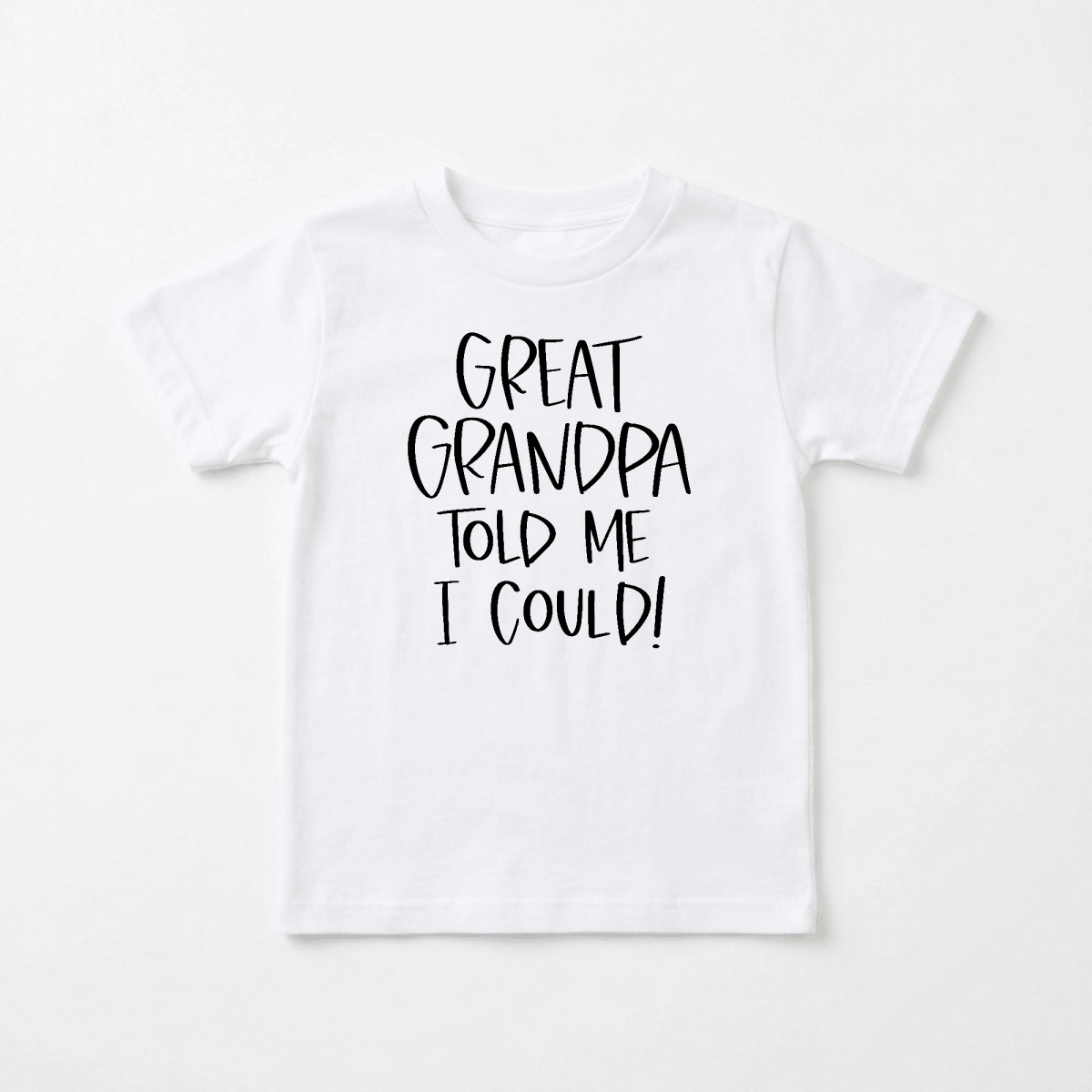 The Toodleroos Great Grandpa Told Me I Could Toddler Shirt – Funny Family Tee features bold black text on a classic white t-shirt that reads, “GREAT GRANDPA TOLD ME I COULD!” Displayed against a plain white background, this charming toddler shirt makes an ideal gift for great-grandpa and is sure to be treasured for years to come.