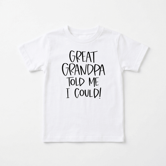 The Toodleroos Great Grandpa Told Me I Could Toddler Shirt – Funny Family Tee features bold black text on a classic white t-shirt that reads, “GREAT GRANDPA TOLD ME I COULD!” Displayed against a plain white background, this charming toddler shirt makes an ideal gift for great-grandpa and is sure to be treasured for years to come.