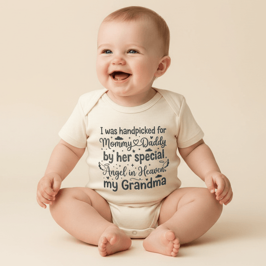 Dressed in the Toodleroos Handpicked by My Angel Grandma Onesie – Memorial Baby Bodysuit, this smiling baby sits sweetly in a cream outfit that honors a loved one with the heartfelt message: “I was handpicked for Mommy & Daddy by her special angel in Heaven, my Grandma,” making it a touching memorial keepsake.