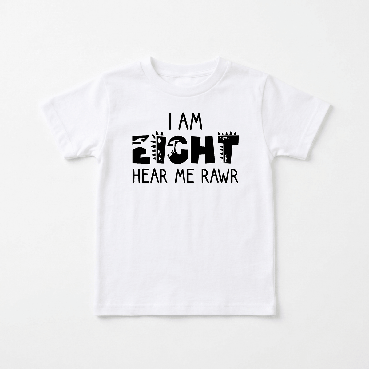 Toodleroos I Am Eight Hear Me Rawr Kids Shirt – Dinosaur 8th Birthday Tee features a playful, black, dinosaur-themed font with the text “I AM EIGHT HEAR ME RAWR” printed on a white T-shirt. This fun dinosaur birthday shirt is perfect for your little one’s 8th birthday celebration or as an everyday kids dino shirt. The shirt is displayed laid flat against a plain, light background.