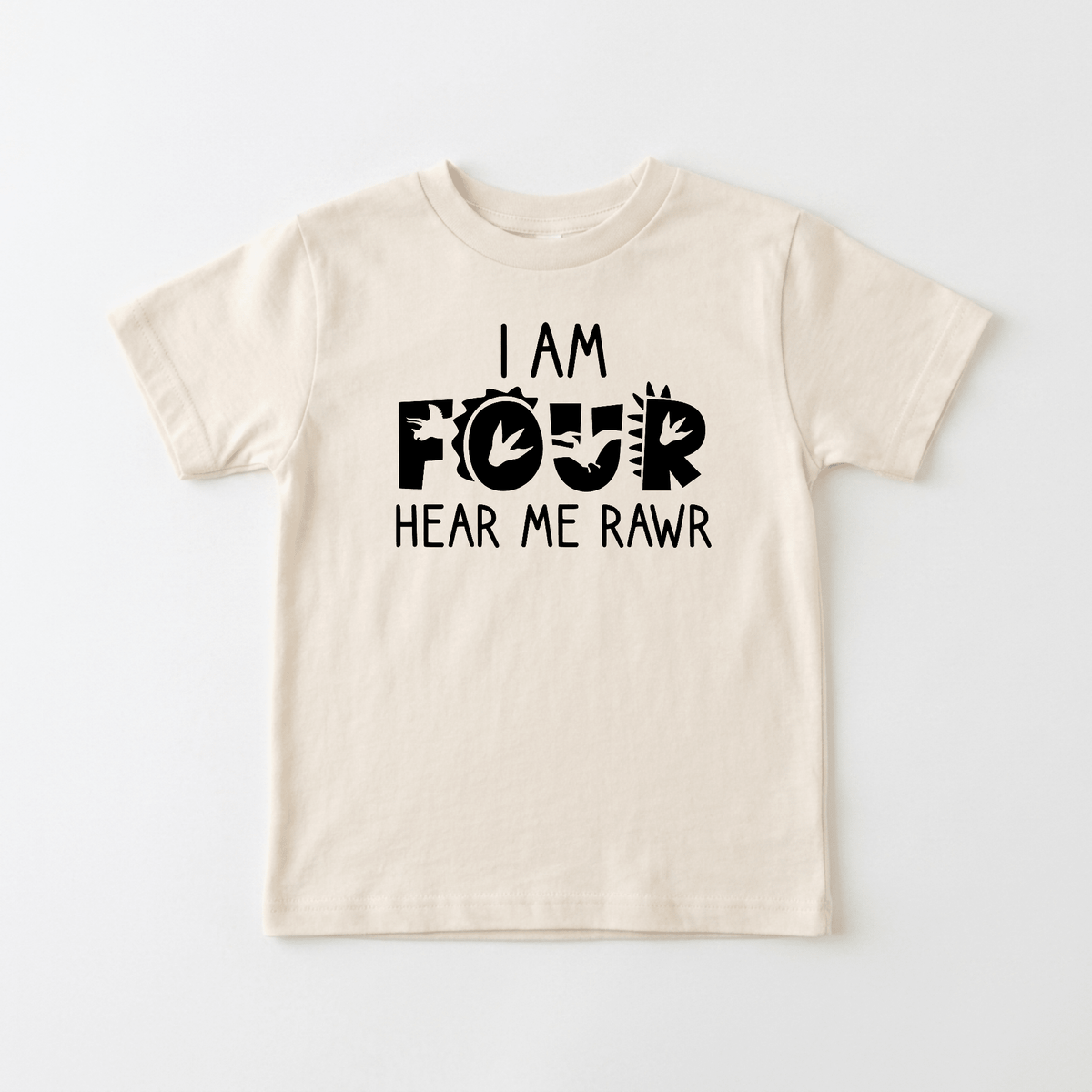 Dress your little one in the Toodleroos I Am Four Hear Me Rawr Kids Shirt – Dinosaur 4th Birthday Tee, a beige t-shirt featuring bold black text that reads “I am four, hear me rawr.” The word “four” is accented with spiky dinosaur details, making it an ideal choice for any child’s big day. Perfect as a dinosaur birthday shirt or a fun 4th birthday celebration outfit.