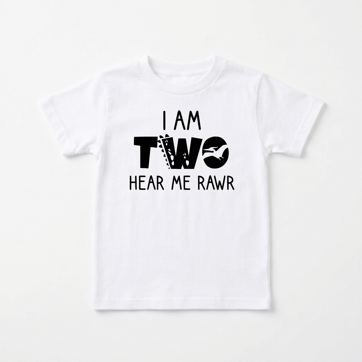 Celebrate turning two in style with the I Am Two Hear Me Rawr Toddler Shirt – Dinosaur 2nd Birthday Tee by Toodleroos. This adorable white children’s t-shirt features bold black text: I AM TWO HEAR ME RAWR, with ‘TWO’ designed in playful, animal-themed lettering. Perfect for a 2nd birthday party or cake smash outfit, this dinosaur toddler shirt brings fun and excitement to every special occasion!.