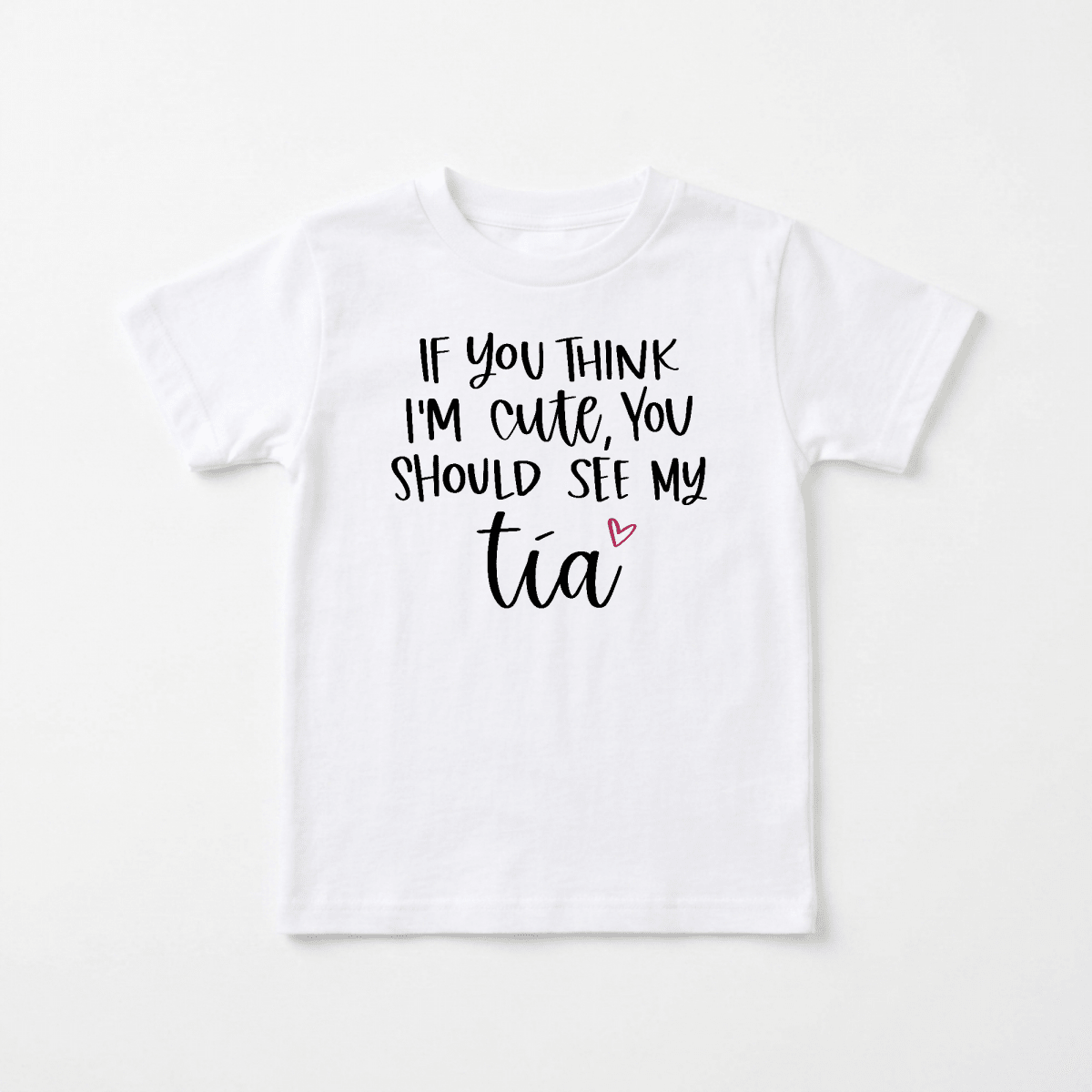 The Toodleroos “If You Think I’m Cute See My Tía” Toddler Shirt is a white children’s t-shirt featuring black text that reads “If you think I’m cute, you should see my tía,” with a small pink heart next to the word “tía.” This funny bilingual tee is the perfect gift for an aunt and makes an adorable tía toddler shirt for little ones who love their favorite aunt.