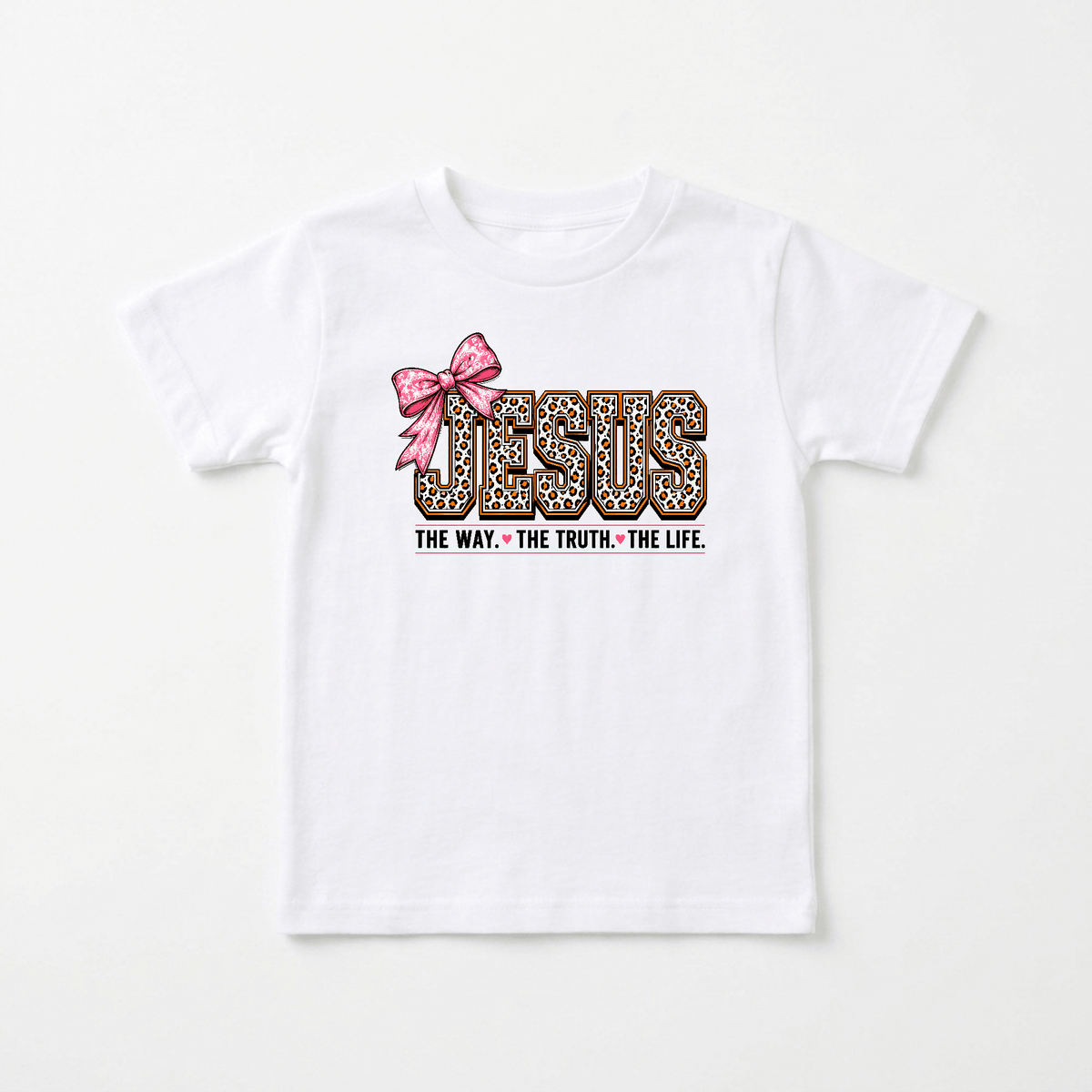 The Jesus The Way The Truth The Life Toddler Girls Shirt – Leopard Print Faith Tee by Toodleroos features JESUS in leopard print letters with a pink bow on the J, and the words “THE WAY. THE TRUTH. THE LIFE.” printed below in black—making this adorable faith-based shirt perfect for little ones to express both their style and spirit.