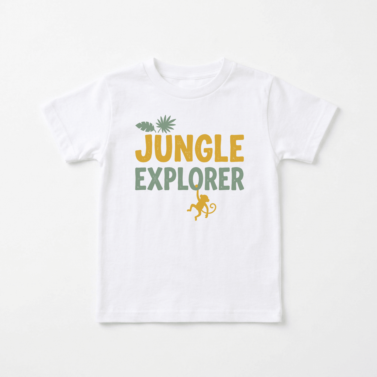 The Toodleroos Jungle Explorer Toddler Shirt – Monkey Safari Tee features “JUNGLE EXPLORER” printed in bold yellow and green letters, accented with a leaf and palm above and a playful monkey silhouette hanging below—making it the perfect safari-themed gift for little nature lovers.