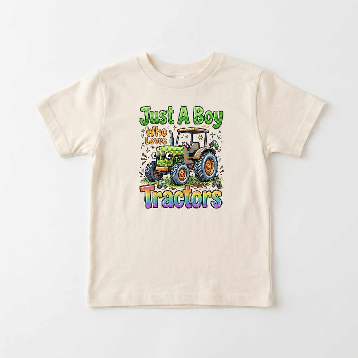 The Toodleroos Just a Boy Who Loves Tractors Toddler Shirt features a colorful cartoon tractor and playful lettering on the front. This adorable farm tractor tee is perfect for any little farm fan who loves big wheels and countryside adventures.