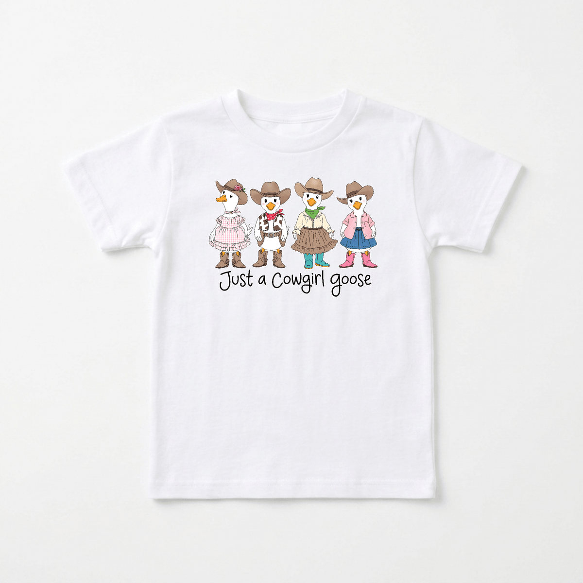 Introducing the Just a Cowgirl Goose Toddler Girls Shirt – Western Tee by Toodleroos! This white t-shirt showcases four cartoon geese dressed in cowgirl hats and boots with the phrase “Just a cowgirl goose” beneath them. Perfect as a western toddler shirt or cowgirl toddler tee, this delightful design from Toodleroos is ideal for your little one’s next country birthday outfit.