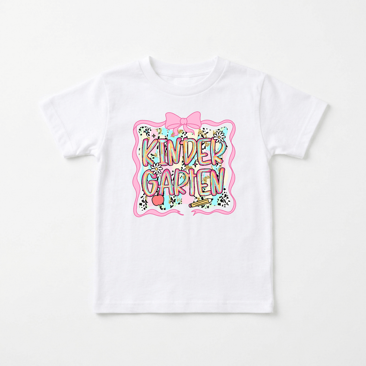 The Toodleroos Kindergarten Youth Tee – Back to School Girls Shirt is a white shirt decorated with a vibrant design that spells out KINDERGARTEN in large, playful letters, surrounded by stars, confetti, and a pink ribbon border—making it the perfect choice for the first day of school or as a favorite back to school shirt.