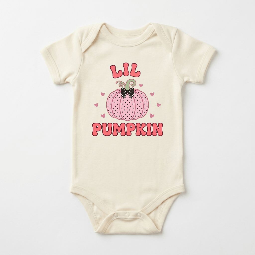 Dress your little one in the Lil Pumpkin Baby Onesie – Pink Polka Dot Bodysuit by Toodleroos. This cream-colored baby bodysuit features a pink pumpkin illustration accented with small pink hearts, with “LIL” written above and “PUMPKIN” in bold pink letters below. Perfect for fall, this adorable onesie is an ideal choice for a pumpkin patch photoshoot or as a cozy autumn outfit.