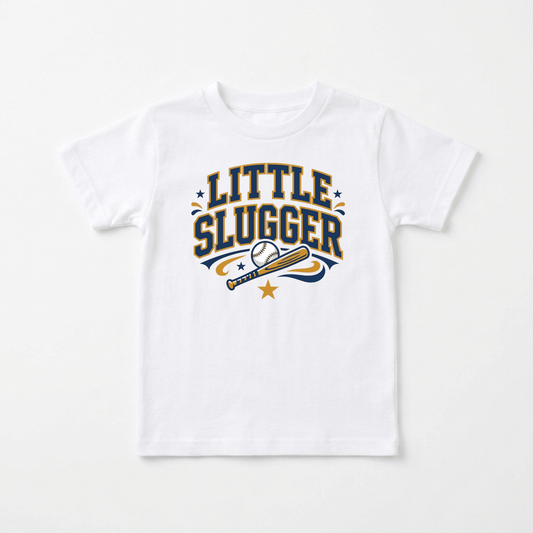 The Toodleroos Little Slugger Toddler Boys Baseball Shirt – Varsity Tee features bold yellow and navy “Little Slugger” lettering above a baseball and bat graphic with small surrounding stars, making this sporty white tee perfect for boys who love the game.