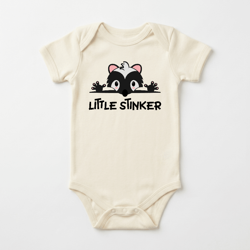 The Toodleroos Little Stinker Baby Onesie – Funny Skunk Bodysuit features a playful design with bold lettering, making this adorable beige bodysuit a perfect baby shower gift.