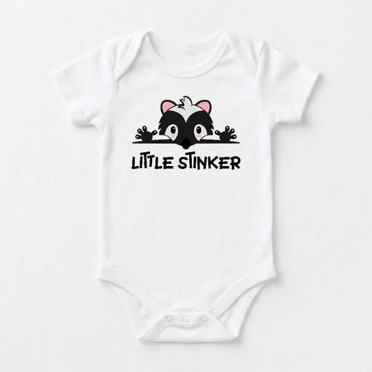 Dress your baby in the Toodleroos Little Stinker Baby Onesie – a funny skunk bodysuit featuring a cute cartoon skunk peeking over bold, playful “LITTLE STINKER” lettering. This adorable onesie makes the perfect baby shower gift!.