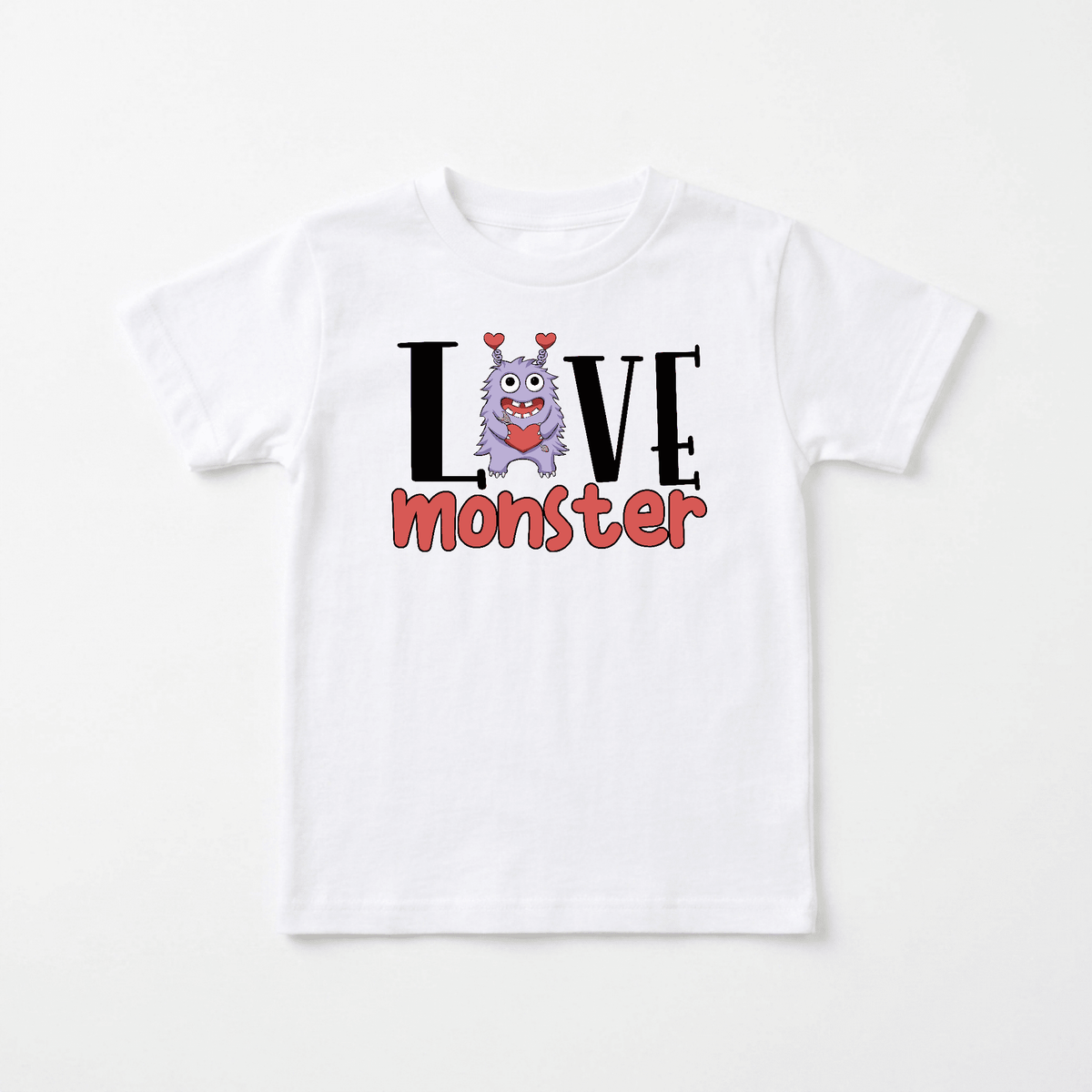 Introducing the Toodleroos Love Monster Toddler Shirt – Valentine’s Day Tee! This adorable white T-shirt features a cute purple cartoon monster with heart-shaped antennae, printed between the words “LOVE” and “monster.” It’s the perfect Valentine’s Day toddler shirt or everyday monster graphic tee for your little one.