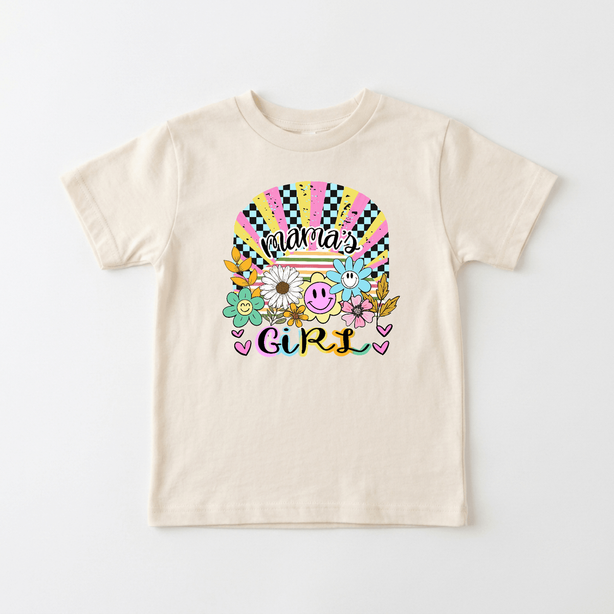 Dress your little one in the Mama’s Girl Retro Kids Shirt – Boho Floral Tee by Toodleroos, featuring a beige color and vibrant front design with colorful “Mama’s Girl” text, flowers, smiley faces, hearts, and a sunburst rainbow—a perfect retro boho kids shirt for children who love cheerful and playful styles.