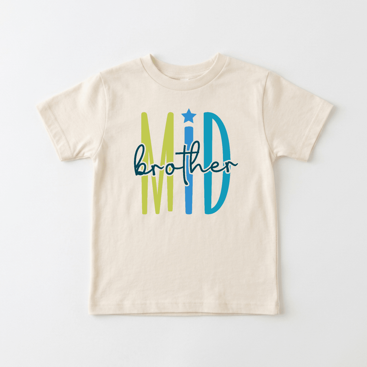 Celebrate your little one’s special place in the family with the Middle Brother Toddler Shirt by Toodleroos! This beige children’s t-shirt features “Mid” in bold green and blue letters (with a star above the “I”) and “brother” in playful black script across the front, making it perfect for sibling announcements or as a unique middle brother shirt. A colorful, fun design that’s ideal for toddlers!.