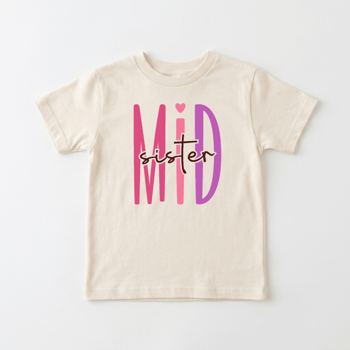 Introducing the Middle Sister Toddler Shirt – Bold Sibling Tee by Toodleroos: This beige toddler tee features “Mid sister” in large, playful pink and purple letters, with “sister” elegantly scripted over “Mid.” Perfect as a mid sister toddler shirt or for matching sibling outfits, this adorable design is a must-have for your collection of sister shirts.