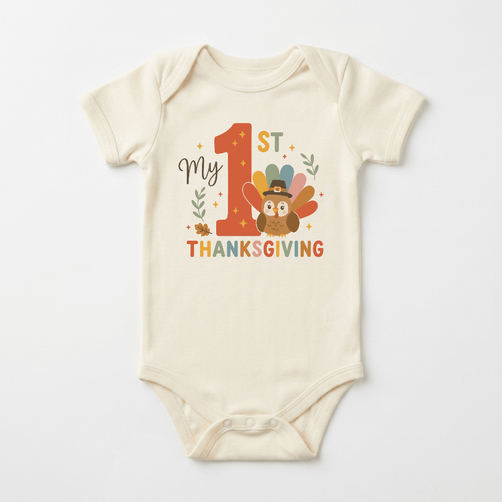 Dress your little one in the Toodleroos Baby’s First Thanksgiving Onesie – My 1st Thanksgiving Turkey Bodysuit: a cozy, cream-colored outfit adorned with “My 1st Thanksgiving” text and a cute turkey sporting a pilgrim hat, surrounded by festive orange, yellow, and green leaves and stars—perfect for celebrating their first holiday!.