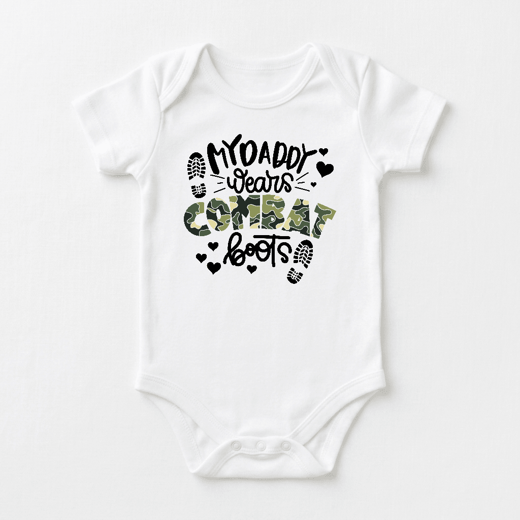 Dress your little one in the Toodleroos “My Daddy Wears Combat Boots Baby Onesie – Camo Design,” featuring a white bodysuit with the phrase “My Daddy Wears Combat Boots” in bold black and camouflage lettering, accented by small heart and boot print graphics. This adorable military baby onesie makes a perfect gift for any military dad.
