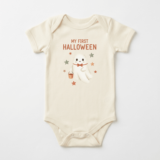 Dress your little one in the Toodleroos Baby’s First Halloween Onesie – Cute Ghost Short-Sleeve Bodysuit! This cream-colored baby bodysuit features an adorable smiling ghost holding a candy bucket, surrounded by orange and brown stars. The text “MY FIRST HALLOWEEN” appears above the cute design in festive orange letters—making it the perfect first Halloween outfit for your baby.
