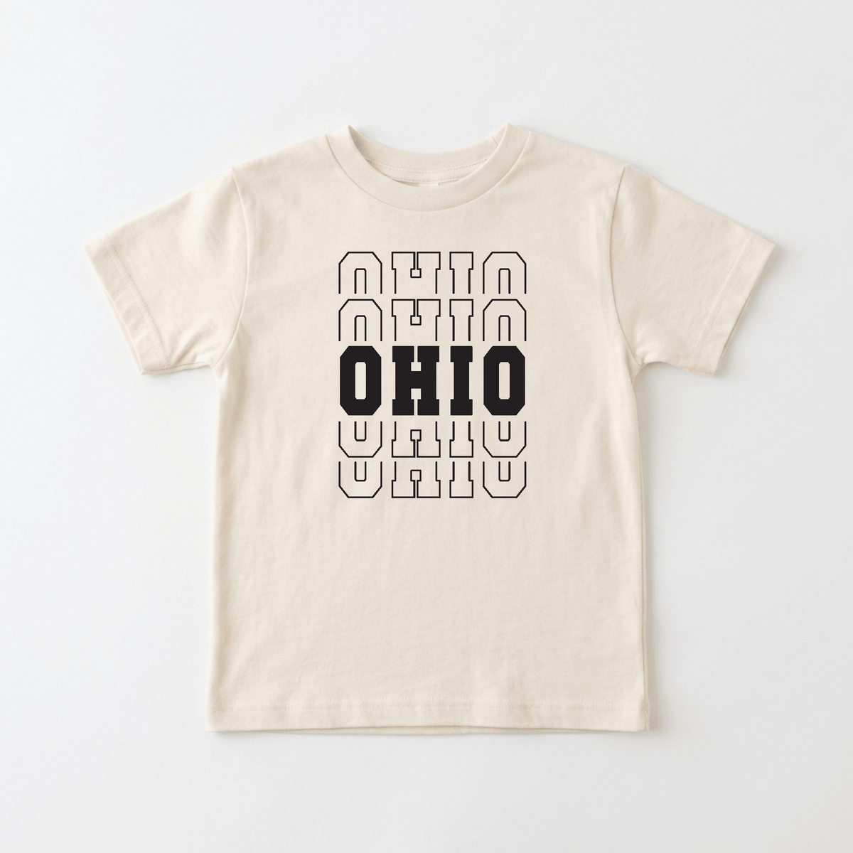 The Ohio Varsity Kids Shirt – State Pride Tee by Toodleroos features a beige design with the word OHIO in bold black letters at the center, layered over three outlined OHIO designs above and below in thin black lines—making it the perfect shirt for little ones to show off Buckeye State pride in classic varsity style.