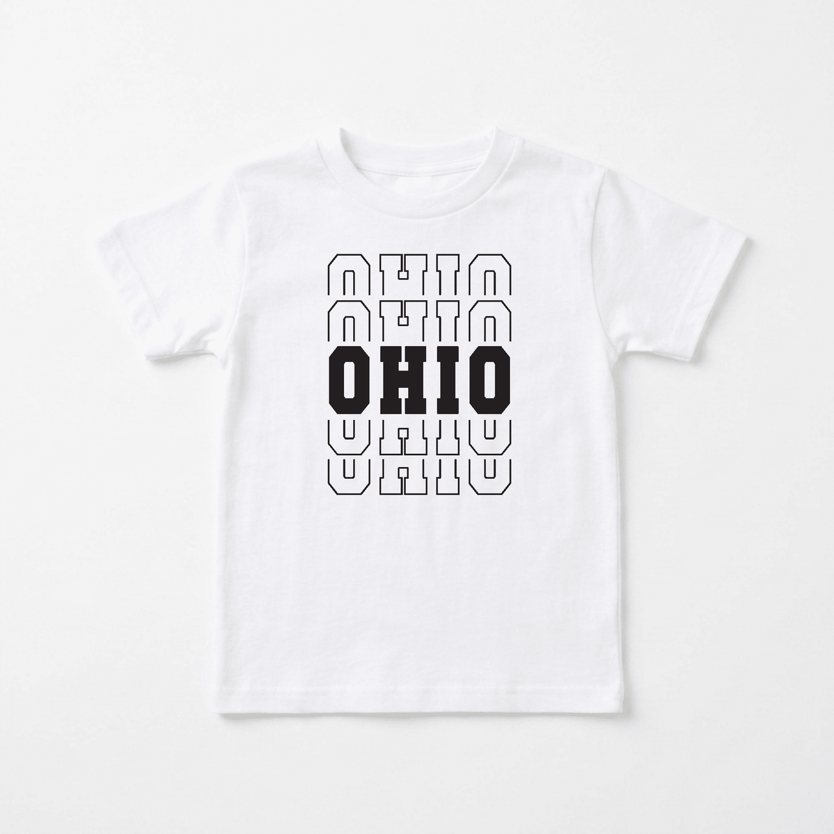 The Toodleroos Ohio Varsity Kids Shirt – State Pride Tee features the word “OHIO” printed three times vertically on a white T-shirt, with the middle “OHIO” in bold black and the top and bottom versions outlined in black. Displayed on a plain white background, this shirt is perfect for any young Buckeye State fan.