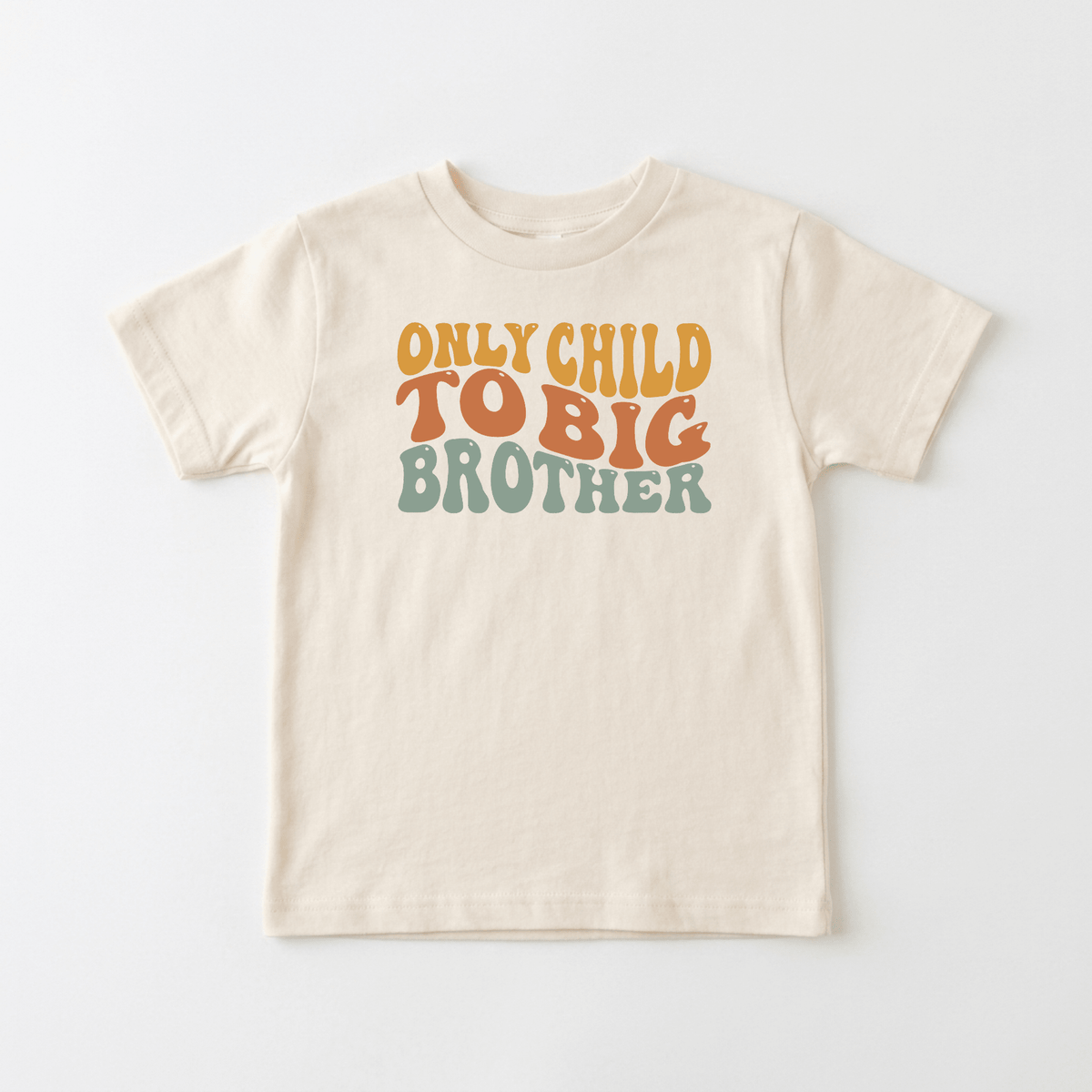 The Only Child to Big Brother Toddler Shirt by Toodleroos features a beige design with “ONLY CHILD TO BIG BROTHER” printed in retro-style orange, yellow, and green letters on the front. This sibling announcement tee is perfect for pregnancy reveals or celebrating your growing family.