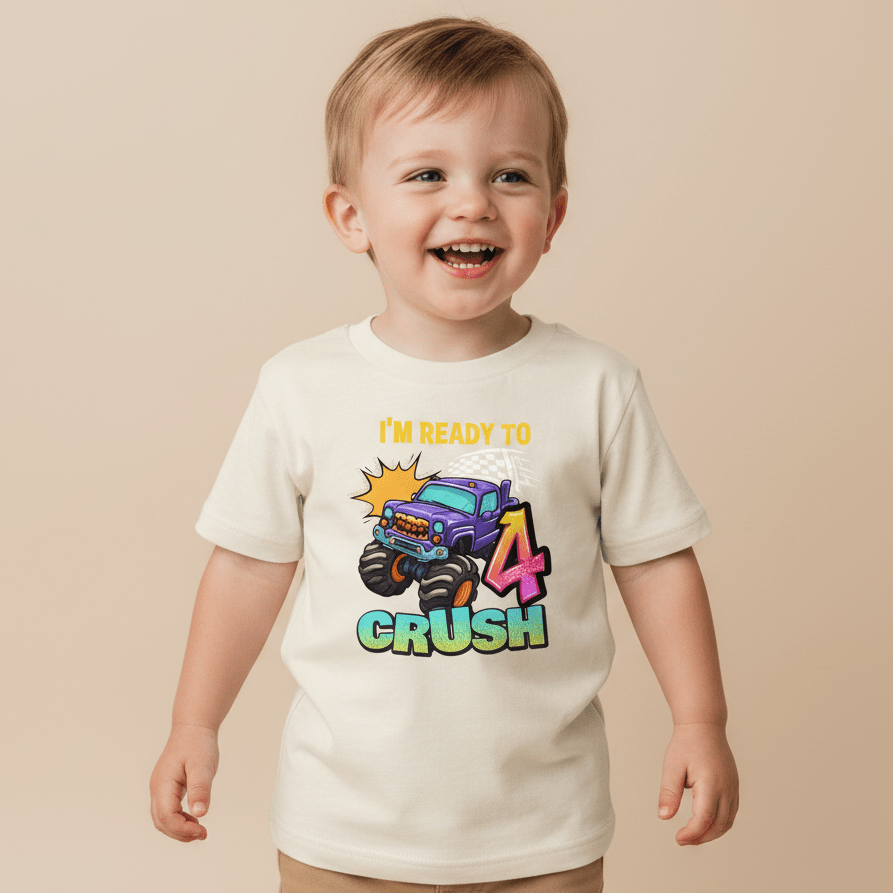 A happy toddler wears the Toodleroos Ready to Crush 4 Toddler Shirt, featuring a playful monster truck graphic and “IM READY TO 4 CRUSH” text—a perfect choice for a monster truck birthday tee or smash cake outfit on your little one’s special day.