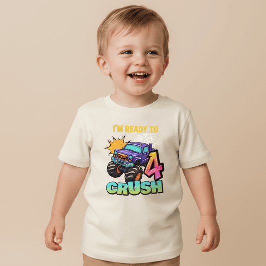 A happy toddler wears the Toodleroos Ready to Crush 4 Toddler Shirt, featuring a playful monster truck graphic and “IM READY TO 4 CRUSH” text—a perfect choice for a monster truck birthday tee or smash cake outfit on your little one’s special day.