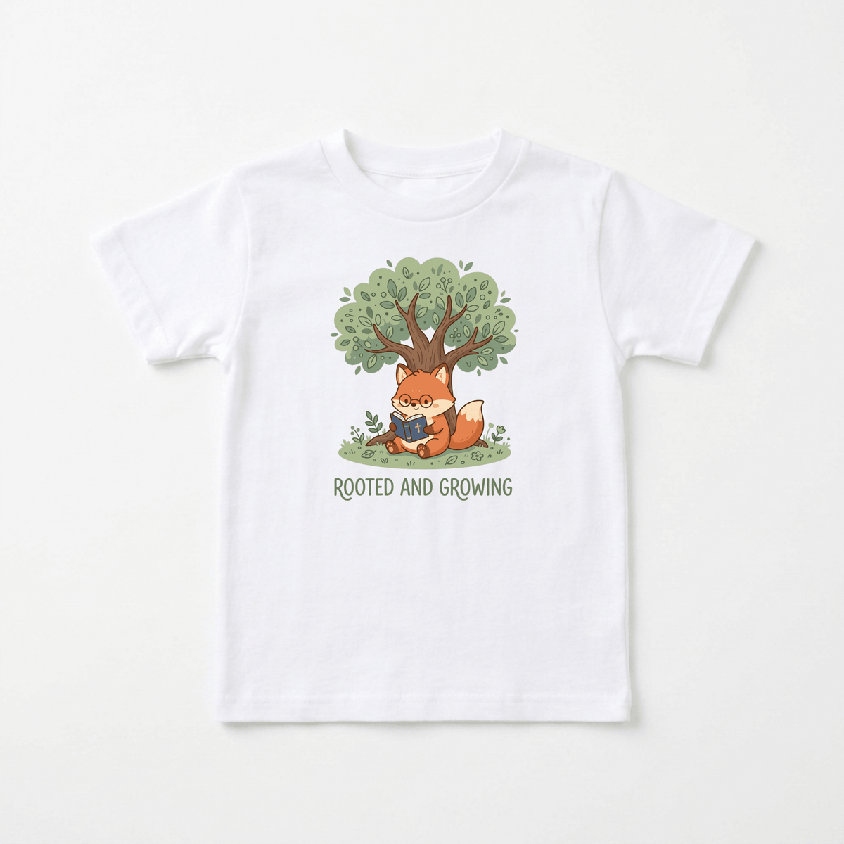 The Toodleroos Rooted and Growing Fox Kids Shirt – Faith Tee features a white base with a charming illustration of a fox reading beneath a green tree. The inspiring message “ROOTED AND GROWING” appears below, making this faith-inspired tee perfect for young readers and animal lovers alike.