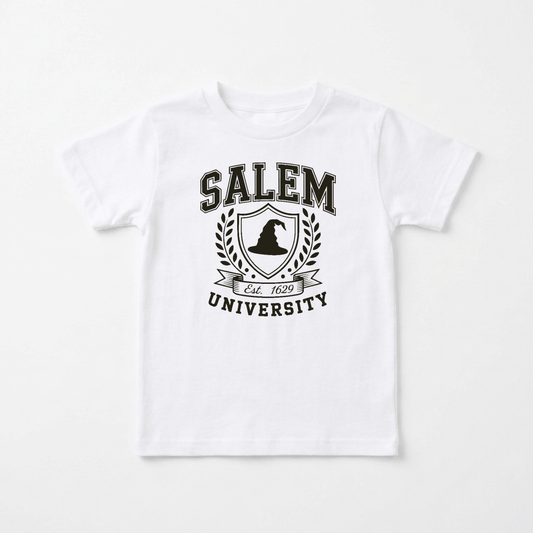 Introducing the Salem University Toddler Shirt – Witch Hat Crest Tee by Toodleroos: a white shirt featuring “Salem University” text, a witch hat crest with a witch silhouette, laurel branches, and “Est. 1692” on a banner—making it the perfect Halloween kids’ shirt or Salem University toddler tee.