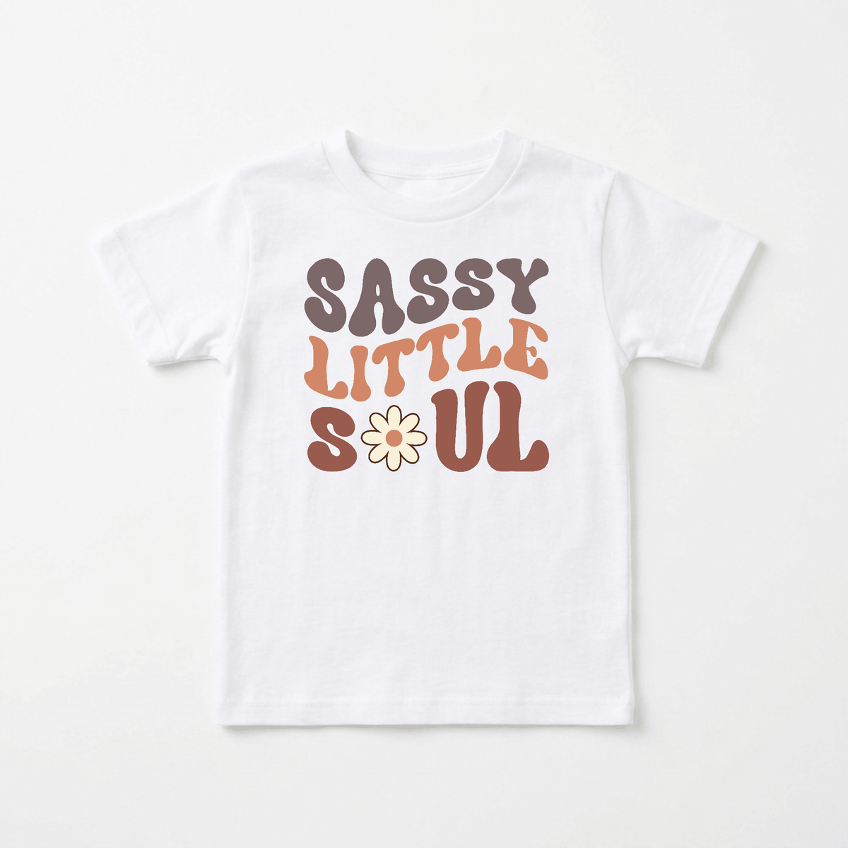 Dress your little free spirit in the Sassy Little Soul Kids Shirt – Boho Retro Tee from Toodleroos. Featuring bold, retro-style lettering in purple, orange, and brown with a daisy flower as the “O” in “Soul,” this white tee brings a playful and fun vibe to any outfit—perfect for adding a touch of boho charm to your child’s wardrobe.