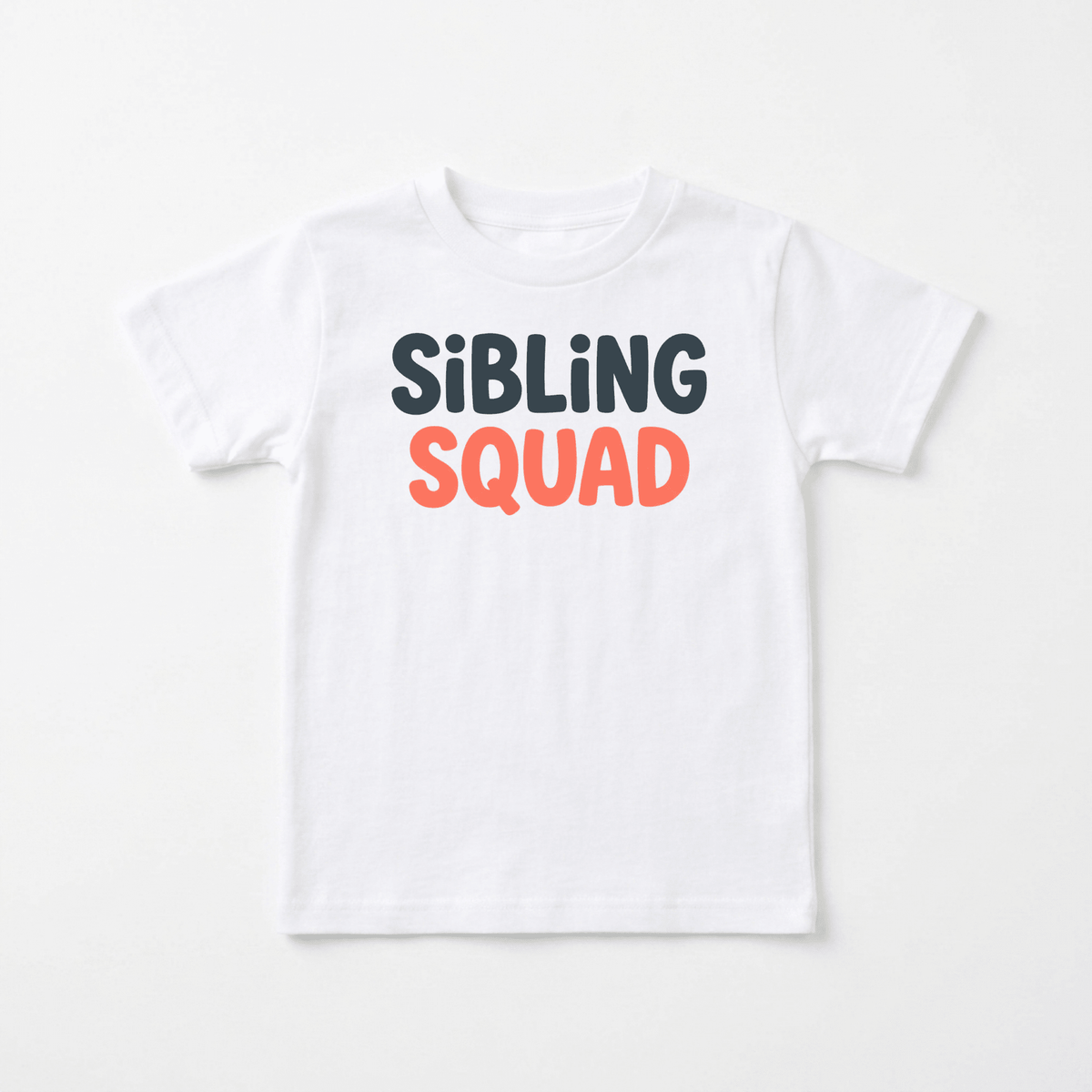 A white Sibling Squad Toddler Shirt from Toodleroos, featuring “SIBLING SQUAD” printed on the front—SIBLING in black and SQUAD in orange. This matching sibling tee is displayed flat on a plain background, ideal for coordinating outfits.