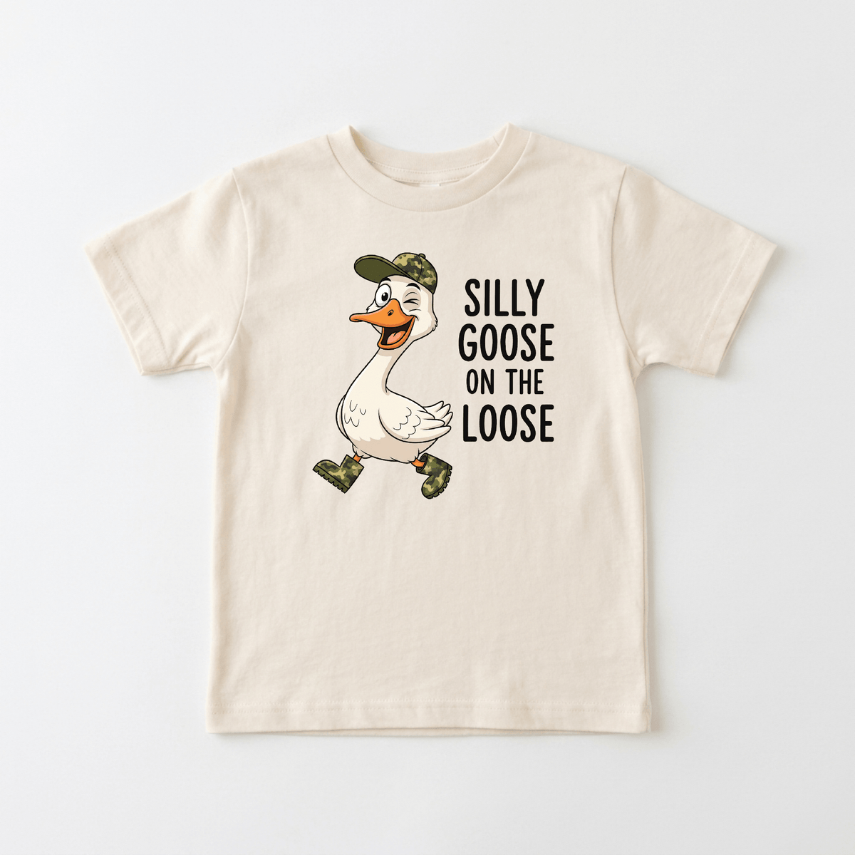The Toodleroos Silly Goose on the Loose Toddler Shirt is a beige tee featuring a cartoon goose in a camouflage hat and boots, with “SILLY GOOSE ON THE LOOSE” printed beside it. This funny goose tee is perfect for little ones who love playful animal t-shirt designs.