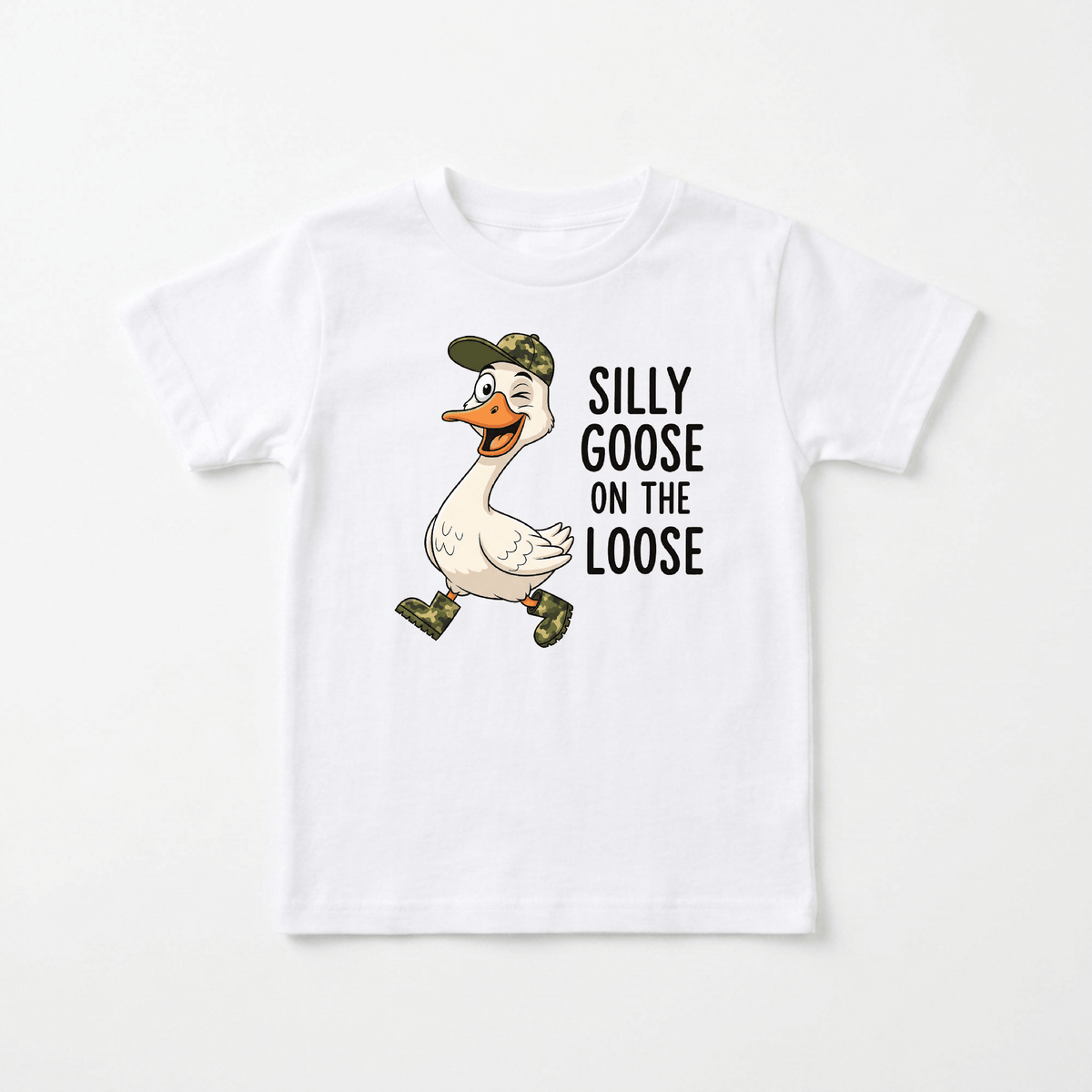 The Toodleroos Silly Goose on the Loose Toddler Shirt is a white tee featuring a cartoon goose in a green cap and boots, smiling as it walks. Next to the cheerful goose, the shirt reads, “Silly goose on the loose.” This funny goose tee is perfect for toddlers who love playful animal shirts.