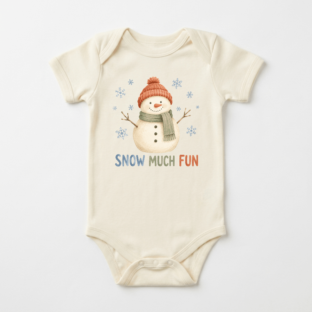 The Toodleroos Snow Much Fun Snowman Baby Onesie is an ivory winter bodysuit showcasing a cheerful snowman in a red hat and green scarf, surrounded by playful snowflakes. “SNOW MUCH FUN” is printed below in colorful letters, making it perfect for baby’s first winter.