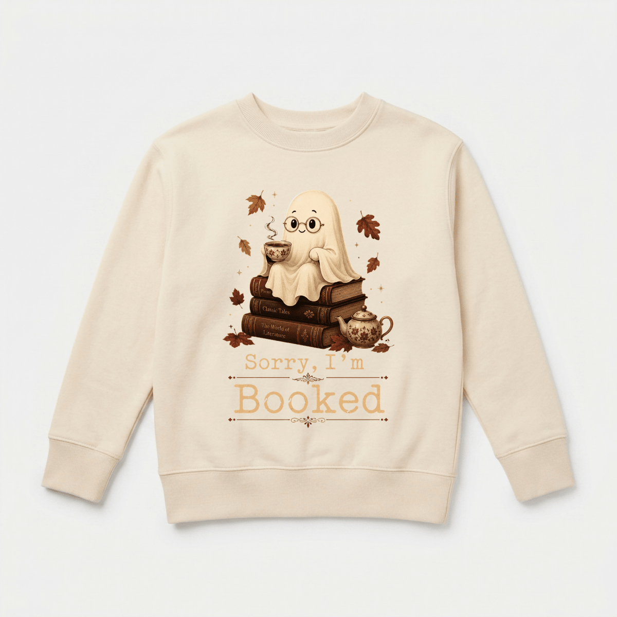 Introducing the Sorry I’m Booked Kids Sweatshirt – Cozy Ghost Reading Crewneck by Toodleroos: a beige sweatshirt featuring an adorable ghost holding tea, perched atop a stack of books and surrounded by leafy accents and a teapot. The front displays the playful phrase “Sorry, I’m Booked.” This cozy fall piece is perfect for little readers who love spooky season—a charming Halloween or autumn outfit from Toodleroos!.