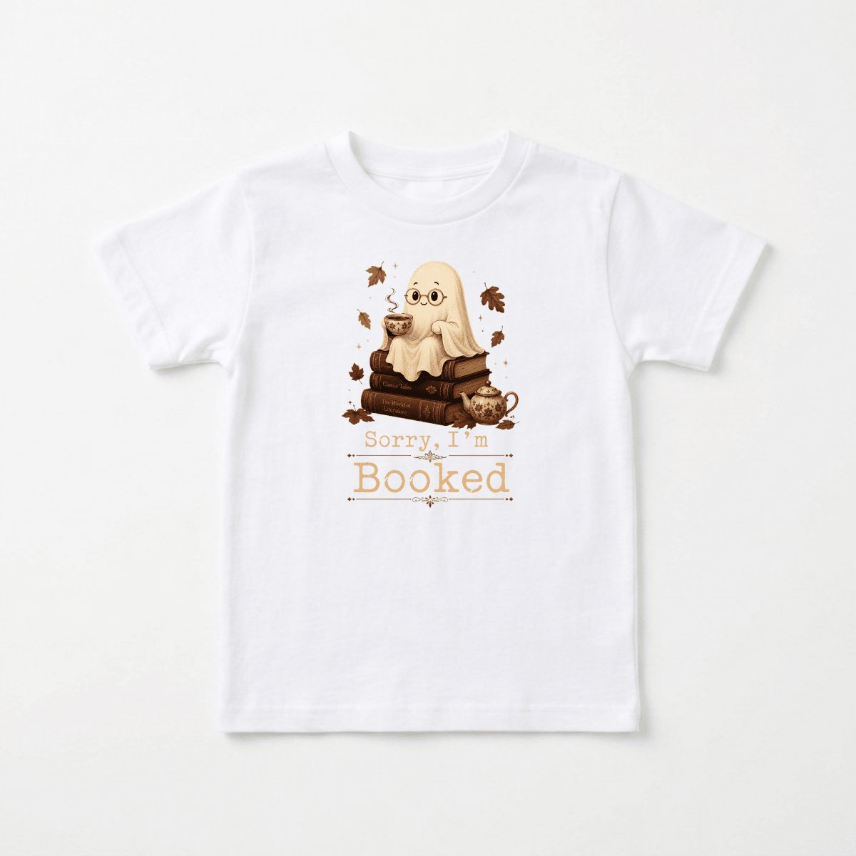 Introducing the Toodleroos “Sorry I’m Booked Toddler Shirt – Cozy Ghost Reading Tee”: a delightful white t-shirt featuring an adorable ghost sipping from a cup, seated on a stack of books surrounded by autumn leaves. Perfect for fall or Halloween, this charming toddler tee is ideal for your little reader’s cozy adventures. The text below reads, “Sorry, I’m Booked.”.