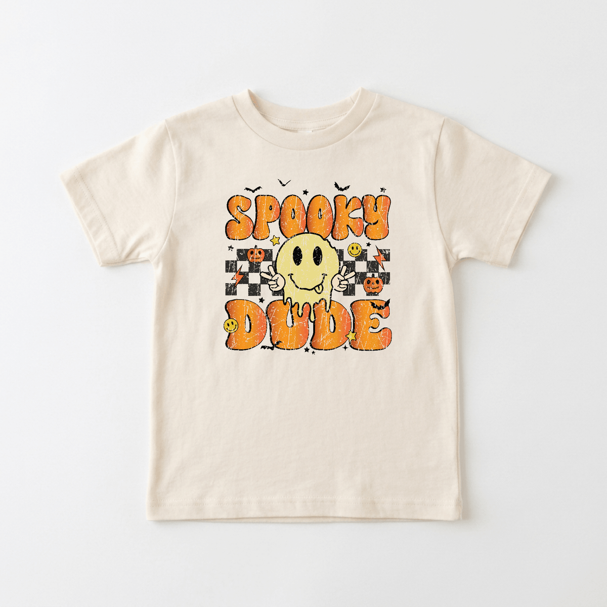 The Toodleroos Spooky Dude Retro Kids Shirt – Halloween Tee features a beige color and showcases “Spooky Dude” in bold orange letters, along with a smiling yellow ghost, jack-o-lanterns, and small bats. With black-and-white checkerboard patterns in the background, this fun Halloween-themed t-shirt is perfect for little ghouls who love playful and spooky kids shirts.