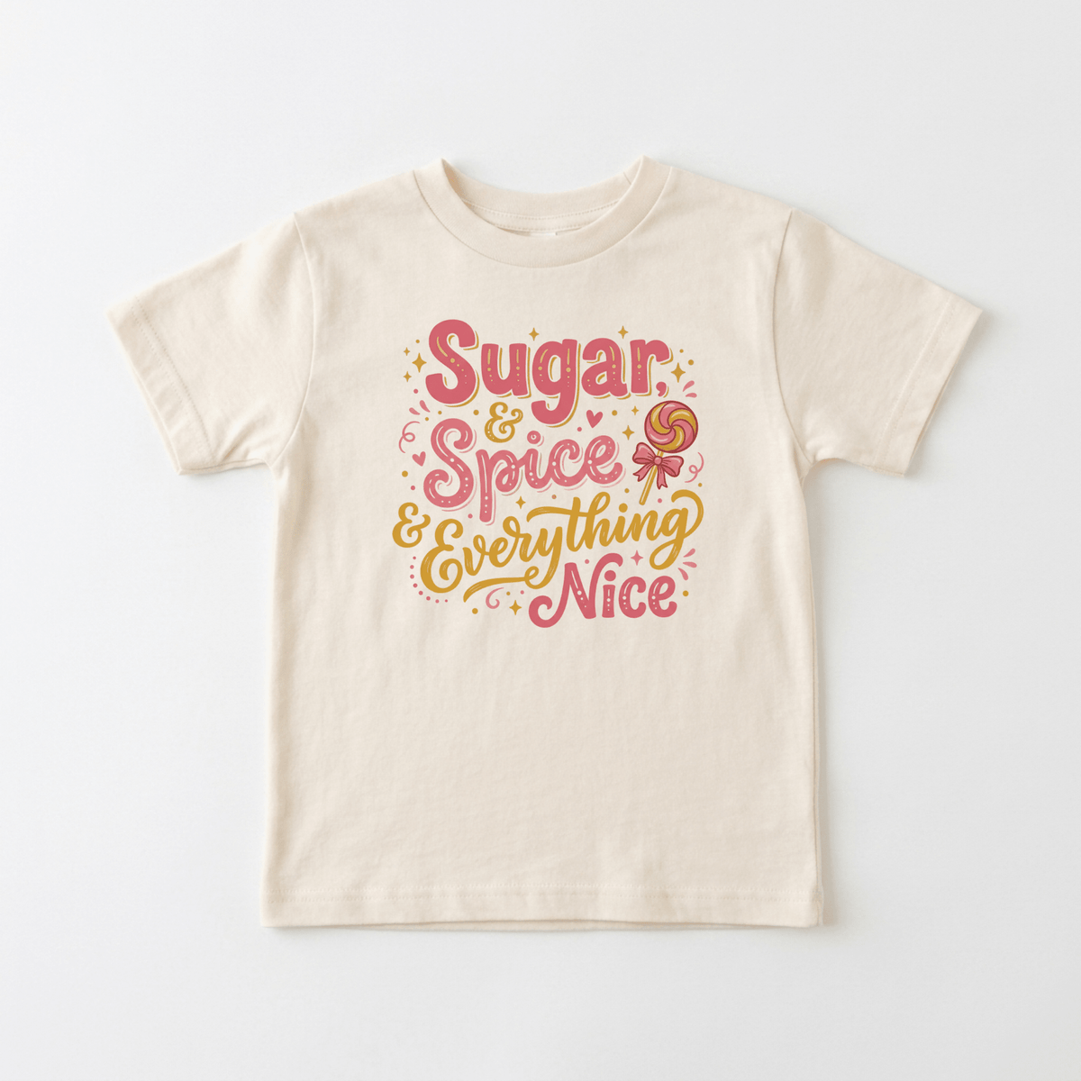 The Sugar and Spice Toddler Girls Shirt – Lollipop Tee by Toodleroos features a beige design with colorful pink and yellow text that reads “Sugar & Spice & Everything Nice.” Adorned with small stars, swirls, and a playful lollipop graphic, this adorable tee is perfect for anyone searching for cute kids shirts or trendy girls shirts. The shirt is displayed flat on a white background.