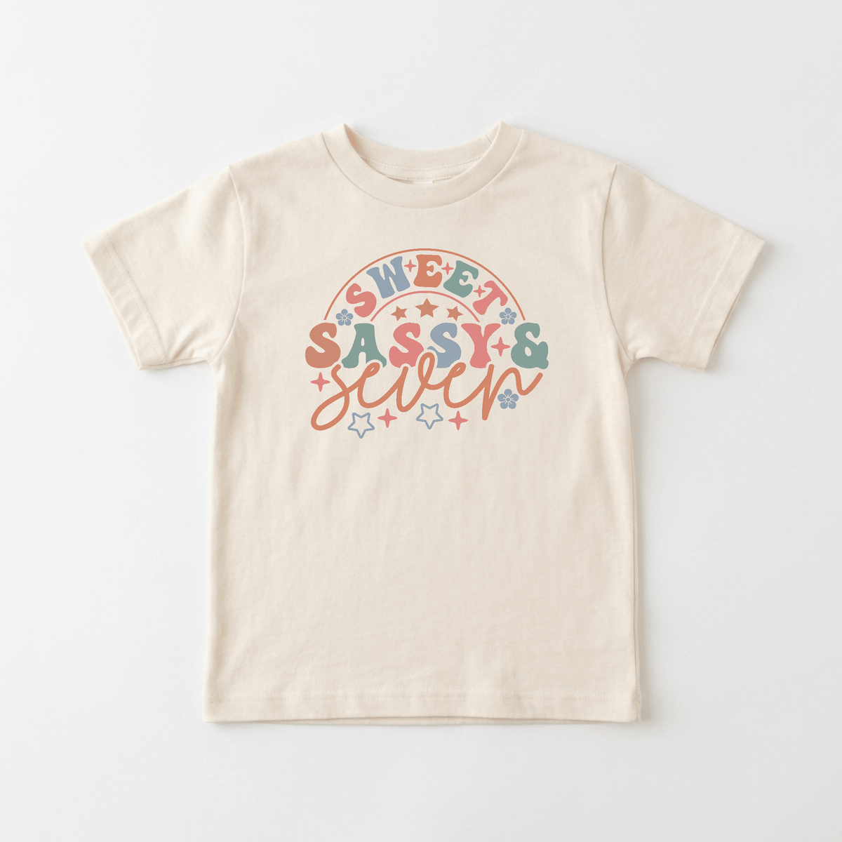 Dress up their big day with the Sweet Sassy & Seven Kids Shirt – Retro 7th Birthday Tee from Toodleroos, featuring colorful retro text and a pastel rainbow with stars on a beige tee—perfect for celebrating your child’s 7th birthday or for any kid who loves vintage-inspired style.